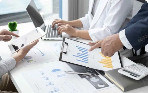 Business professionals working on laptops deploying specialised expertise through outsourcing